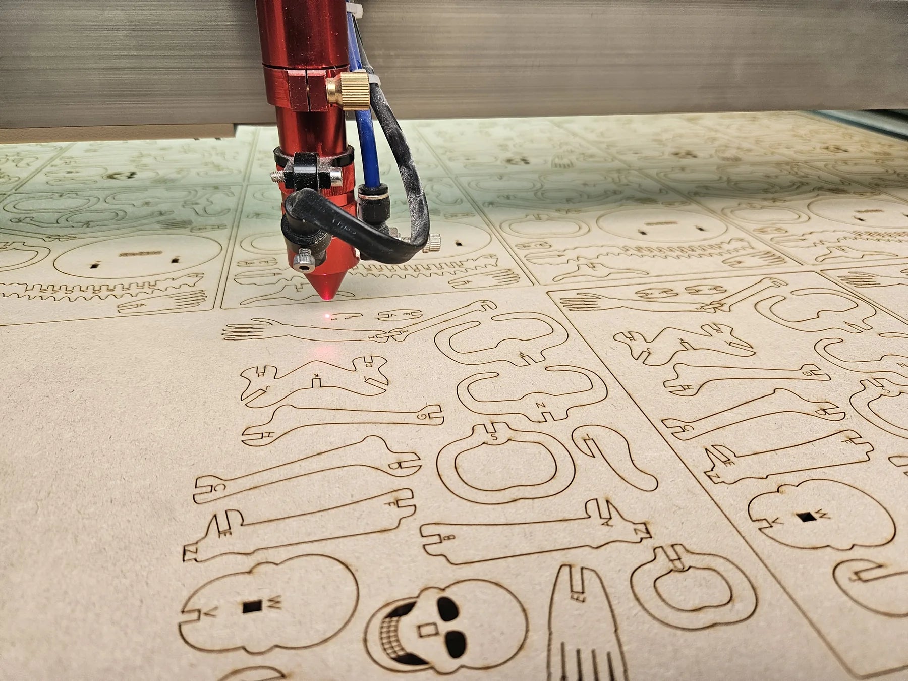 Sheet with model kit parts during laser cutting
